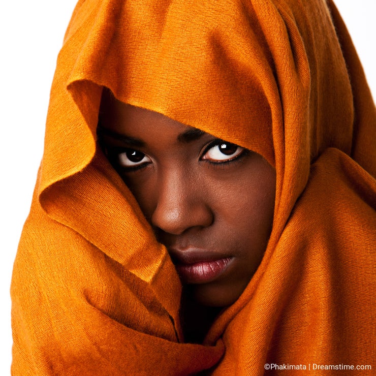 Mysterious female face in ocher head wrap