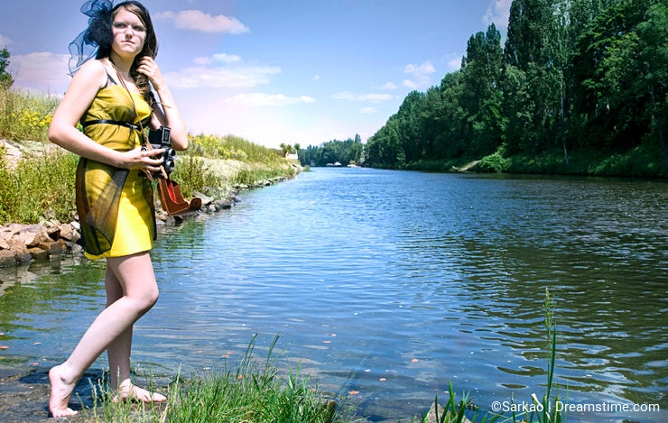 Retro young woman near the river