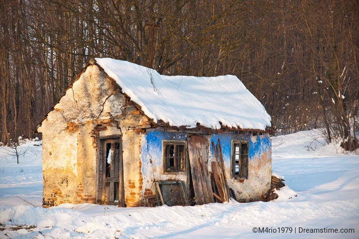 Very Old and ruined house in winter scenery