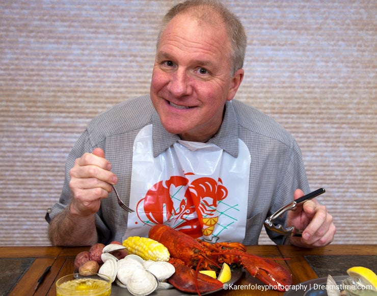 Man eating lobster dinner