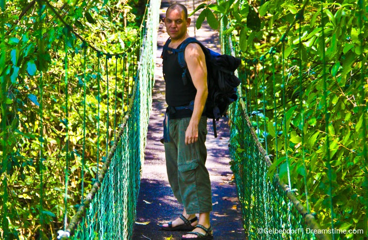 Tourist on a jungle bridge