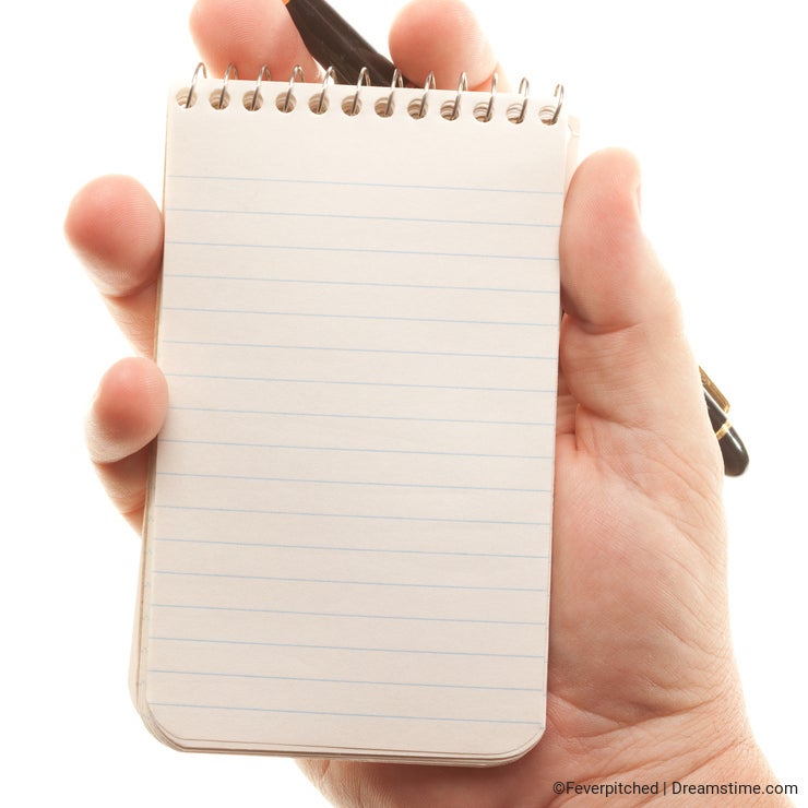 Male Hands Holding Pen and Pad of Paper