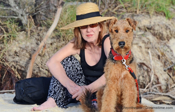 Elegant woman & Airedale Terrier dog on vacation