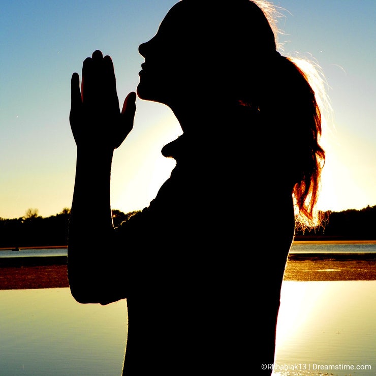 Girl Praying by Lake