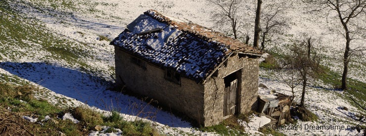 Alpine hut covered with snow