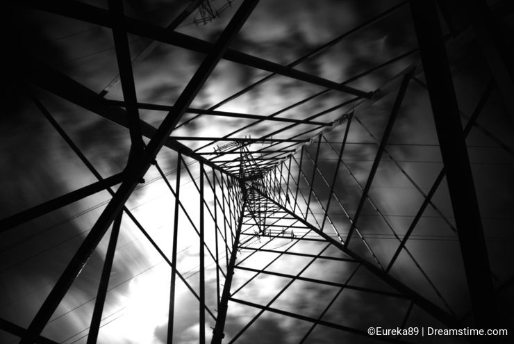 Electricity Pylon with clouds moving in Black and White