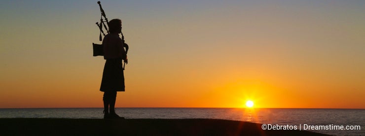 Bagpipe player silhouette sunset