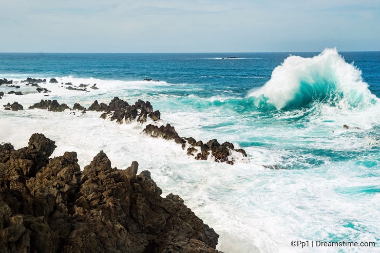 Ocean wave splashing rock shore