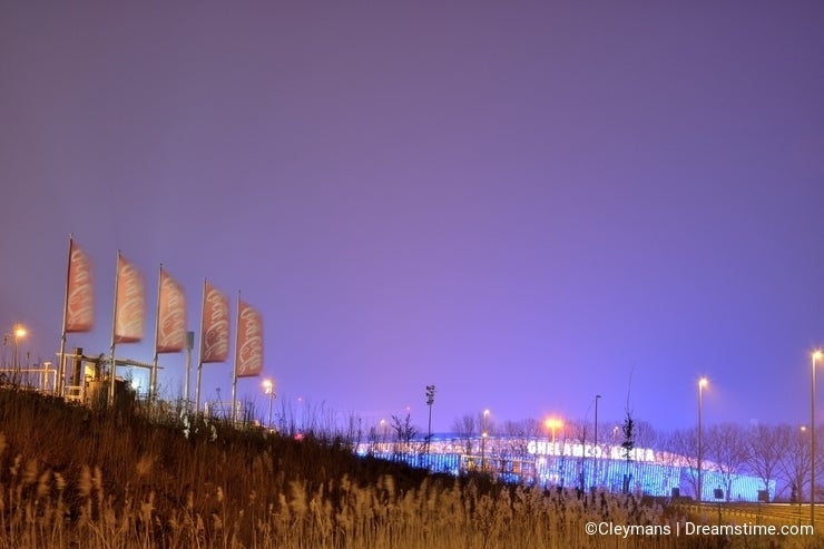 Coca Cola flags, Belgian branch in Ghent at night and ghelamco Arena football stadium
