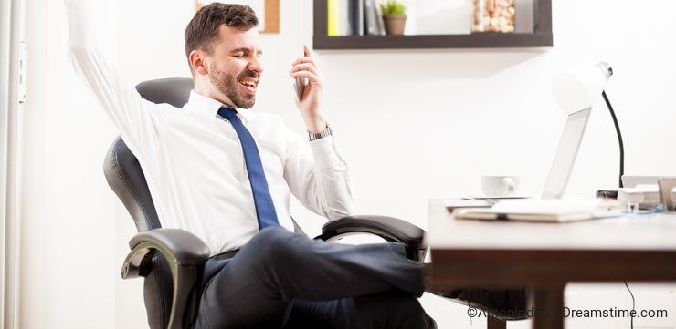 Businessman getting great news on the phone