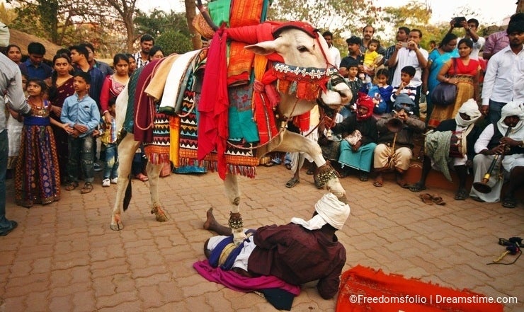 Folk dancers play street act on Sankranti festival