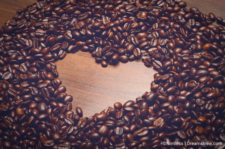 Coffe beans on the table in the morning with heart shape inside