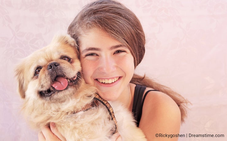 Teen girl with pekingese dog