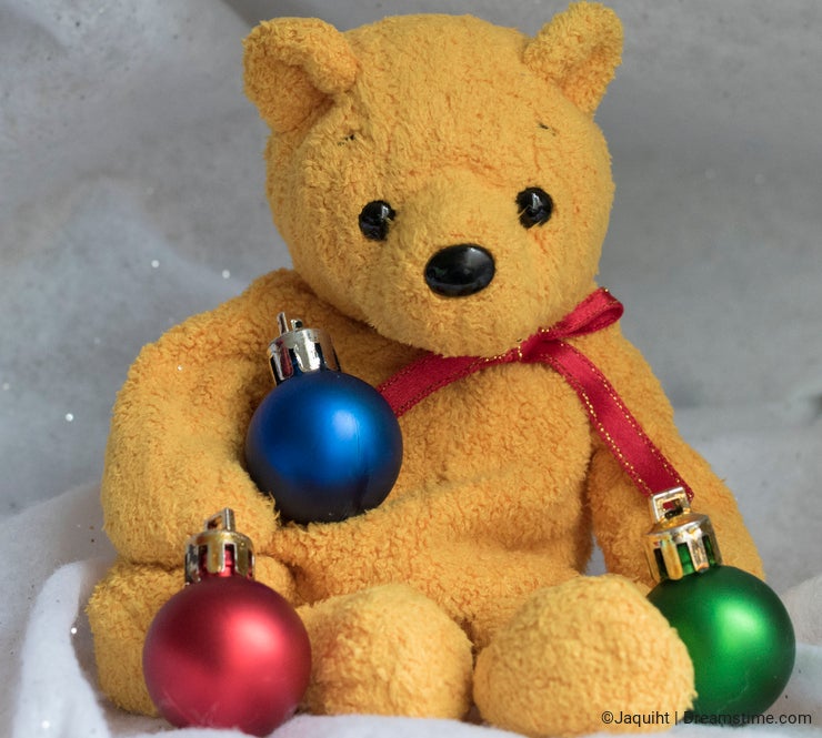 A yellow bear with Christmas baubles