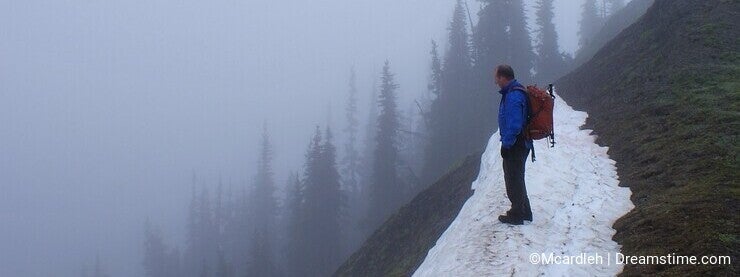 Forty year old man on steep mountain snow