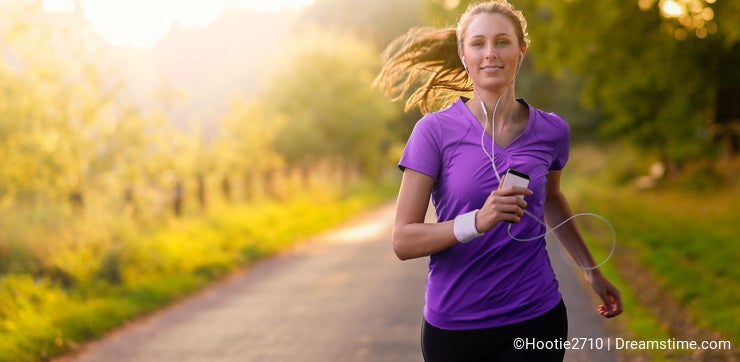 Woman listening to music while jogging