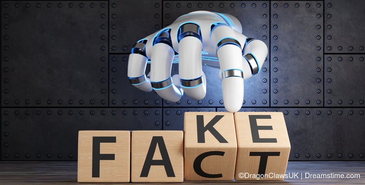 White robotic hand turning 2 wooden blocks revealing the words FACT and FAKE