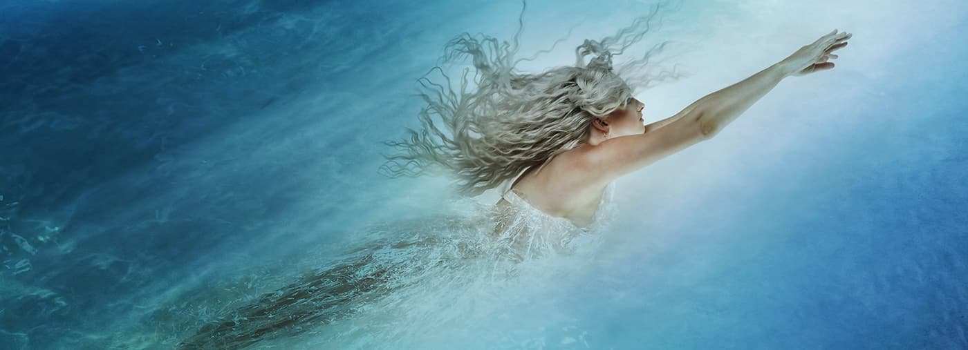 young woman floating in the depths of a blue ocean concept photo