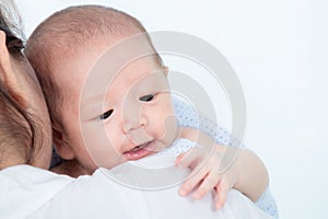 0-1 month Asian newborn baby lie down on mom shoulder after wake up, mother help infant Expel the wind in the stomach after