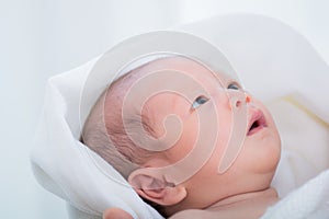 0-1 month Asian newborn baby looking to her mom with curiosity, infant open eye effect with light but still not see anything, baby