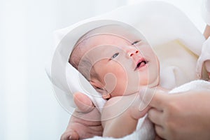 0-1 month Asian newborn baby looking to her mom with curiosity, infant open eye effect with light but still not see anything, baby