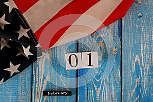01 February calendar beautifully waving star and striped American flag on old wooden board