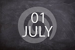 01 July text with blackboard background for calendar.