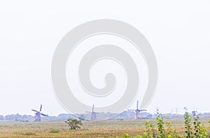 02-10-2021, Kinderdijk, The Netherlands, View of traditional windmills on a misty grey day in Kinderdijk, The