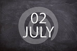 02 July text with blackboard background for calendar.