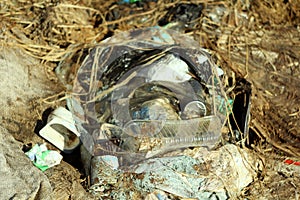 03-05-2020. Syktyvkar, Russia. Heap of garbage with bags, plastic, dry grass, cardboard and bottles