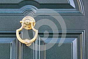 08 09 2018 Atri, Italy - golden door knocker on a traditional dark door