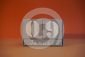 09 Januar on wooden grey cubes. Calendar cube date 9 January. Concept of date. Copy space for text. Educational cubes