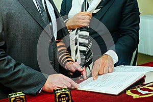 0Hand of boy reading the Jewish Torah at Bar Mitzvah 5 SEPTEMBER 2016 USA