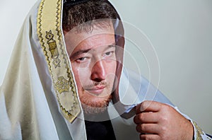 0Orthodox Jew wrapped with traditional religious talit at prayer in the jewish man with kippah