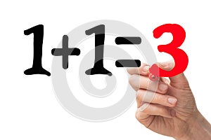 1+1=3 concept with hand writing down the number `3` in red marker pen