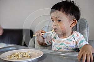 1-2 years old child enjoying his lunch