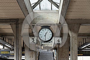 1:31 p.m. on The station clock and platform number 3 and 4 indicators in the Acton Town station