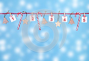 1-5 part of Advent calendar. Sheets with numbers, wooden christmas toys, candy canes on red ribbon on blue background
