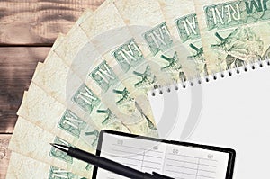 1 Brazilian real bills fan and notepad with contact book and black pen. Concept of financial planning and business strategy