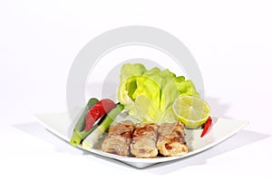 1.	crispy springrolls on dish with salad