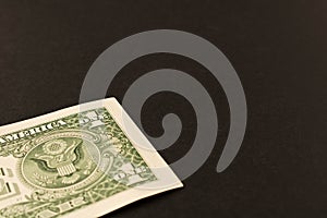1 dollar bill on a dark background . Close up. The concept of saving money