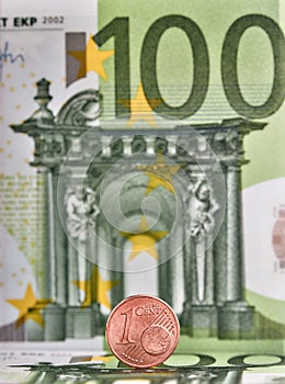 1 Euro cent against 100 Euro banknote, coins and banknotes of the single European currency. Money background