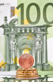 1 Euro cent against 100 Euro banknote, coins and banknotes of the single European currency. Money background