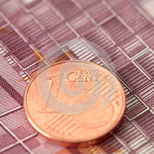 1 Euro cent against 100 Euro banknote, coins and banknotes of the single European currency. Money background