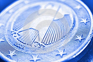 1 euro coin issued in Germany close-up. Obverse with the Federal Eagle. Light blue tinted economic background or backdrop.