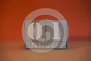 1 Februar on wooden grey cubes. Calendar cube date 01 February. Concept of date. Copy space for text. Educational cubes