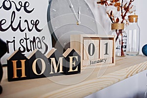 1 January wooden calendar with home sign. Happy winter holidays