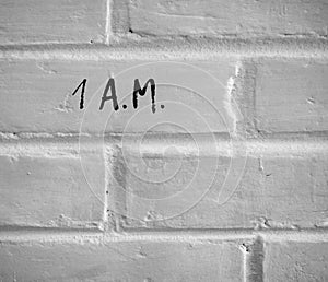 1 A.M. WRITTEN ON WHITE PLAIN BRICK WALL