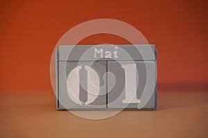 1 Mai on wooden grey cubes. Calendar cube date 01 May. Concept of date. Copy space for text. Educational cube