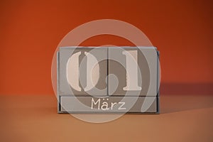 1 Marz on wooden grey cubes. Calendar cube date 01 March. Concept of date. Copy space for text. Educational cubes